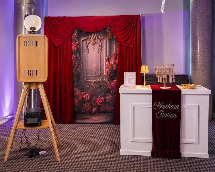 Photo booth, printer and Keychain Station set up indoors.